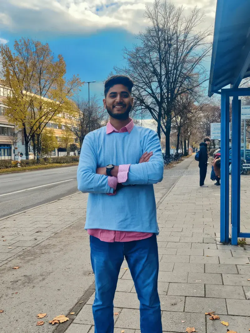 Suprabhat Kumar, Senior Frontend Engineer, standing on a tree-lined street in Munich